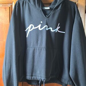 Black hoodie, pink brand